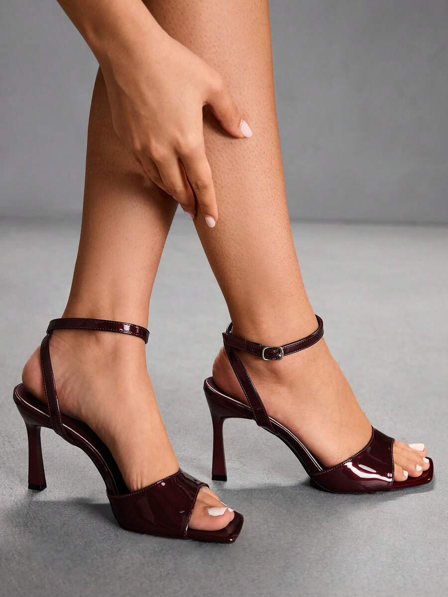 Women's peep toe ankle strap high heel sandals featuring a sleek stiletto heel and adjustable buckle closure.