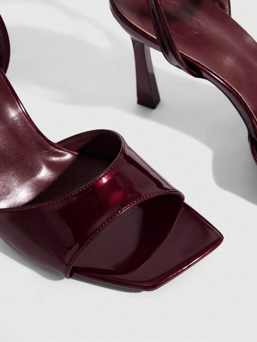 Women's peep toe ankle strap high heel sandals featuring a sleek stiletto heel and adjustable buckle closure.