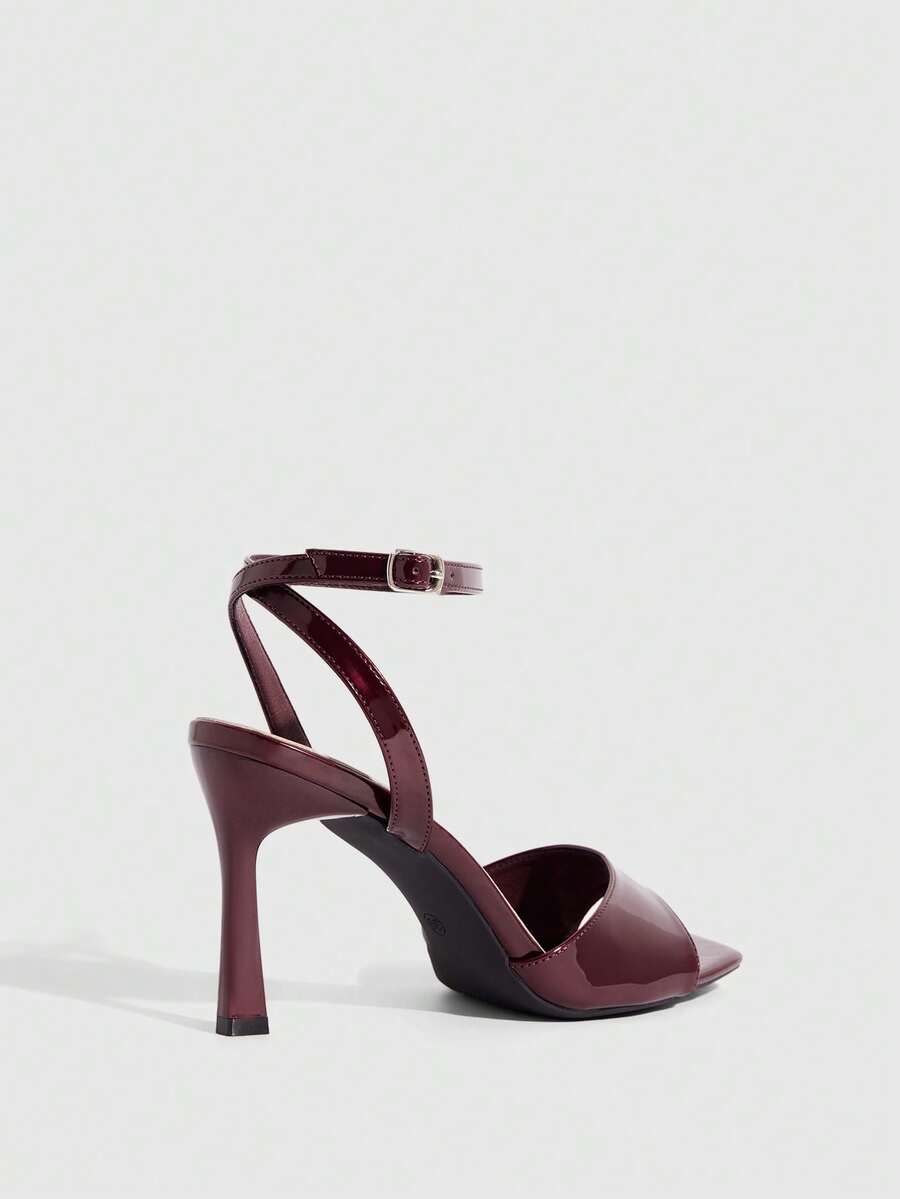 Women's peep toe ankle strap high heel sandals featuring a sleek stiletto heel and adjustable buckle closure.