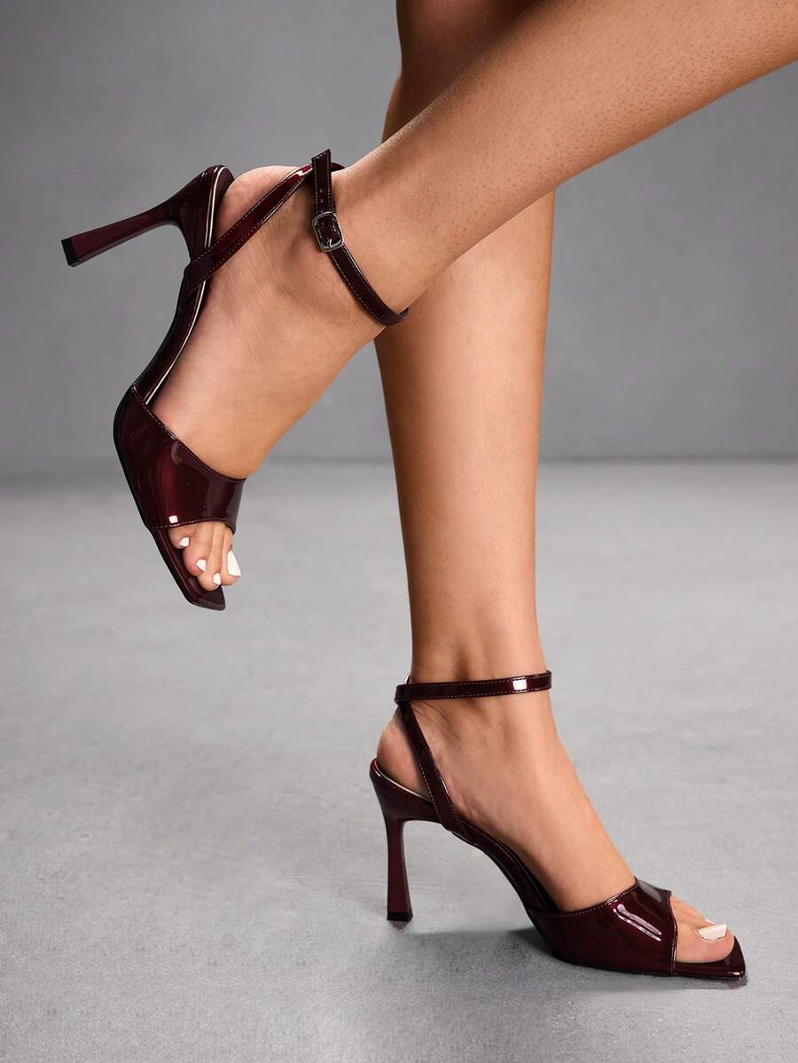 Women's peep toe ankle strap high heel sandals featuring a sleek stiletto heel and adjustable buckle closure.