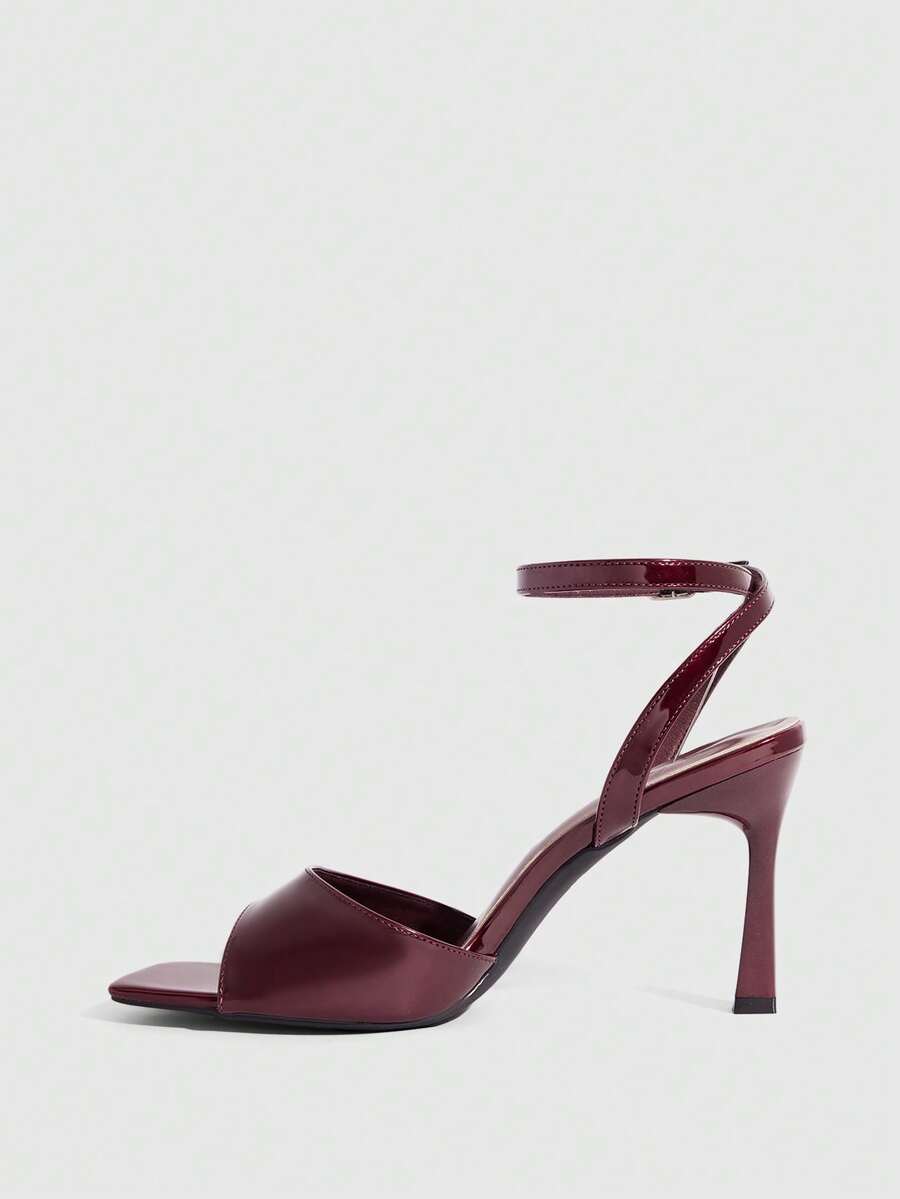 Women's peep toe ankle strap high heel sandals featuring a sleek stiletto heel and adjustable buckle closure.