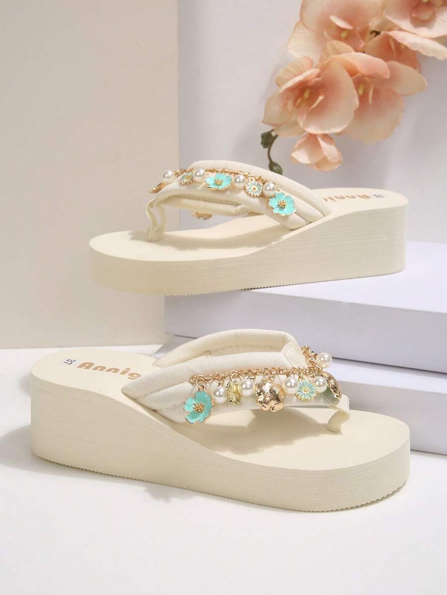 Beige platform wedge flip flop slippers featuring decorative chain and shell details with EVA sole for women.
