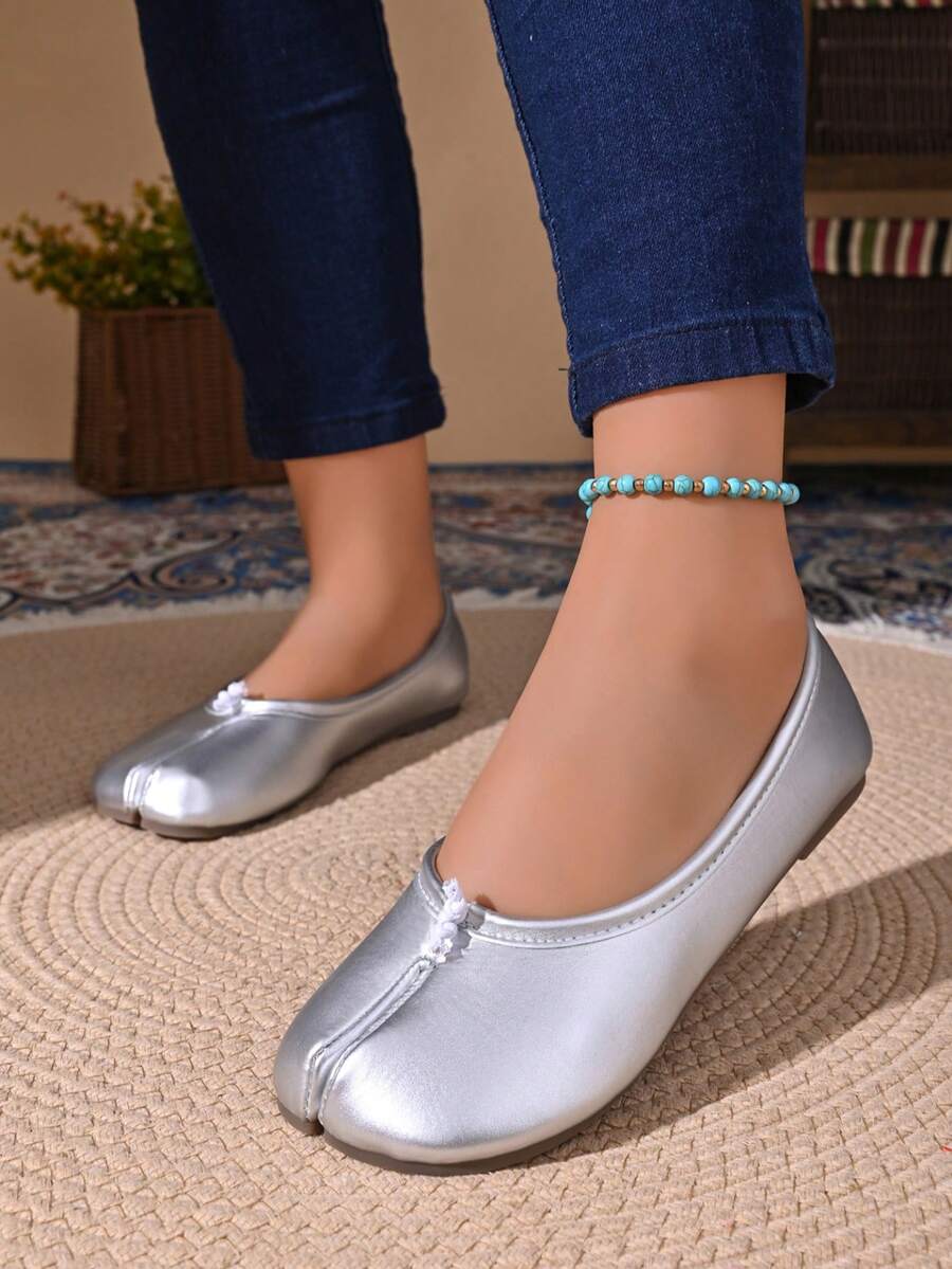 Women's white split-toe slip-on flat shoes with braided accent and rubber sole