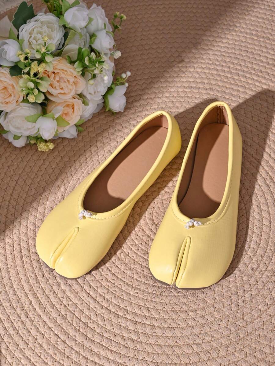 Women's white split-toe slip-on flat shoes with braided accent and rubber sole