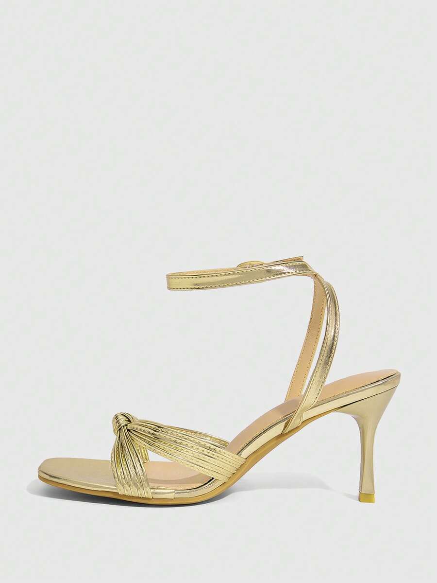 Women's high heel sandals featuring pleated strap detailing, an adjustable ankle strap with buckle closure, round open toe, and slim stiletto heel.