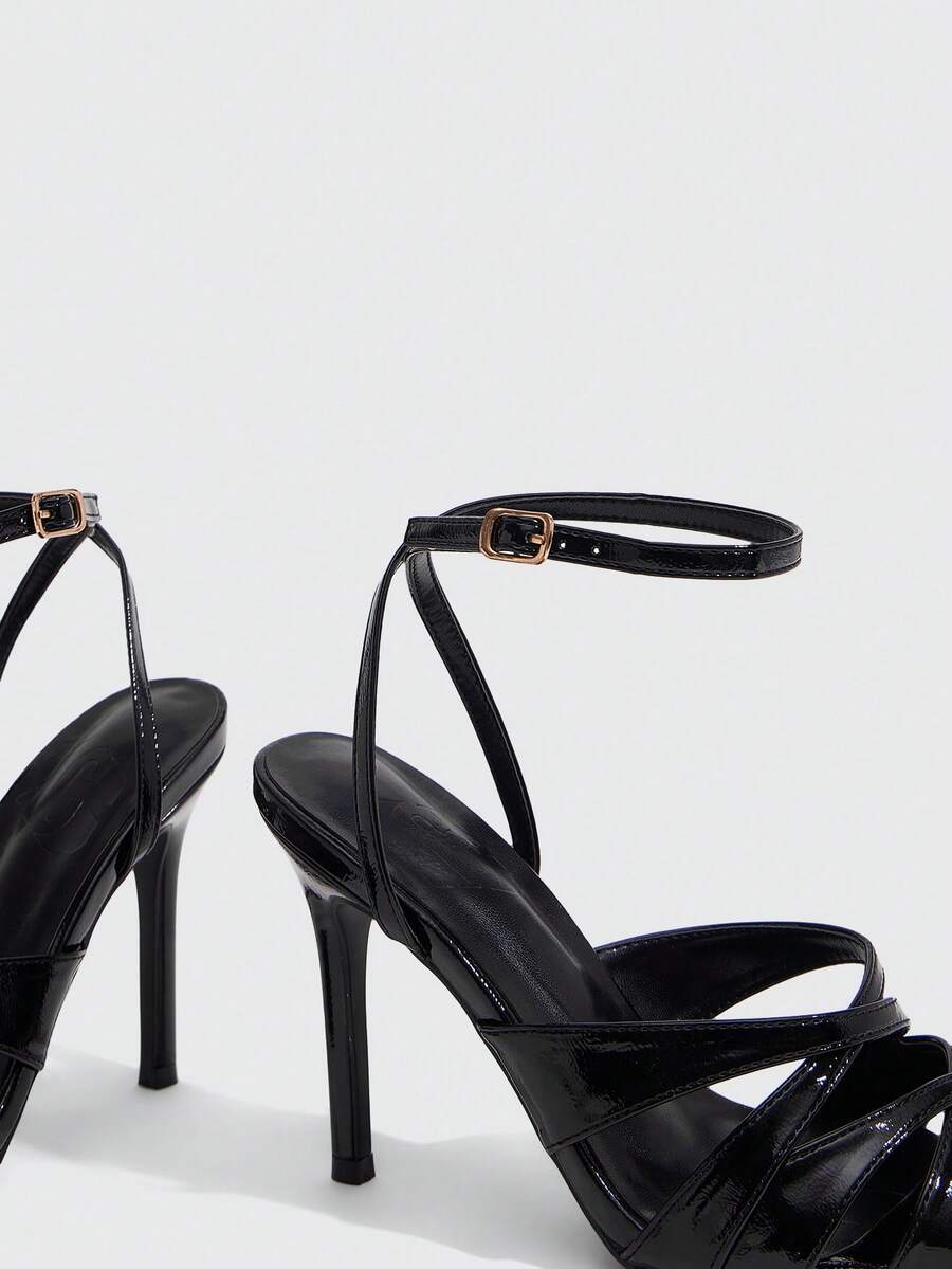 Women's open toe high stiletto sandals with cut-out cross straps and adjustable ankle buckle closure.