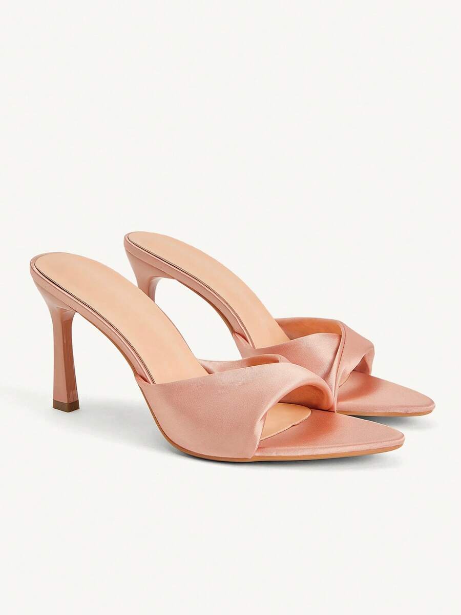 Women's peep toe high-heeled stiletto sandals with slingback strap in light metallic finish.