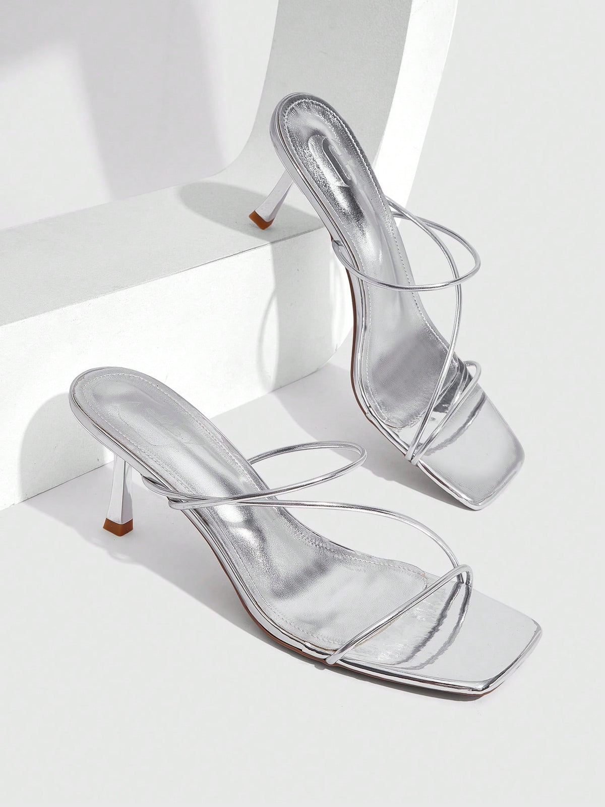 Women's open toe stiletto heel sandals featuring square toe design, criss-cross rhinestone slim straps, and secure ankle strap.