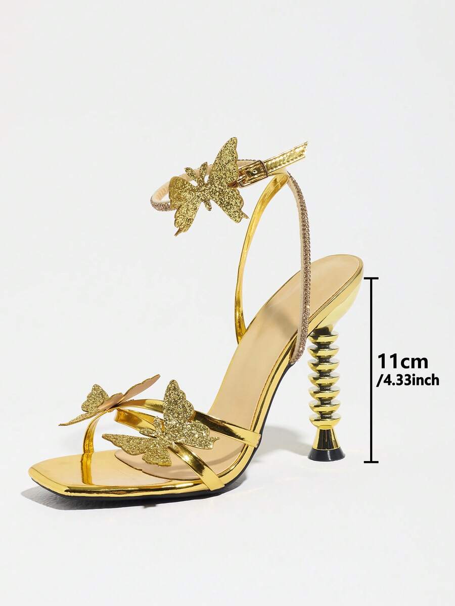 Women's gold high heel sandals featuring open toe, stiletto heel, bow accent, and adjustable ankle strap.