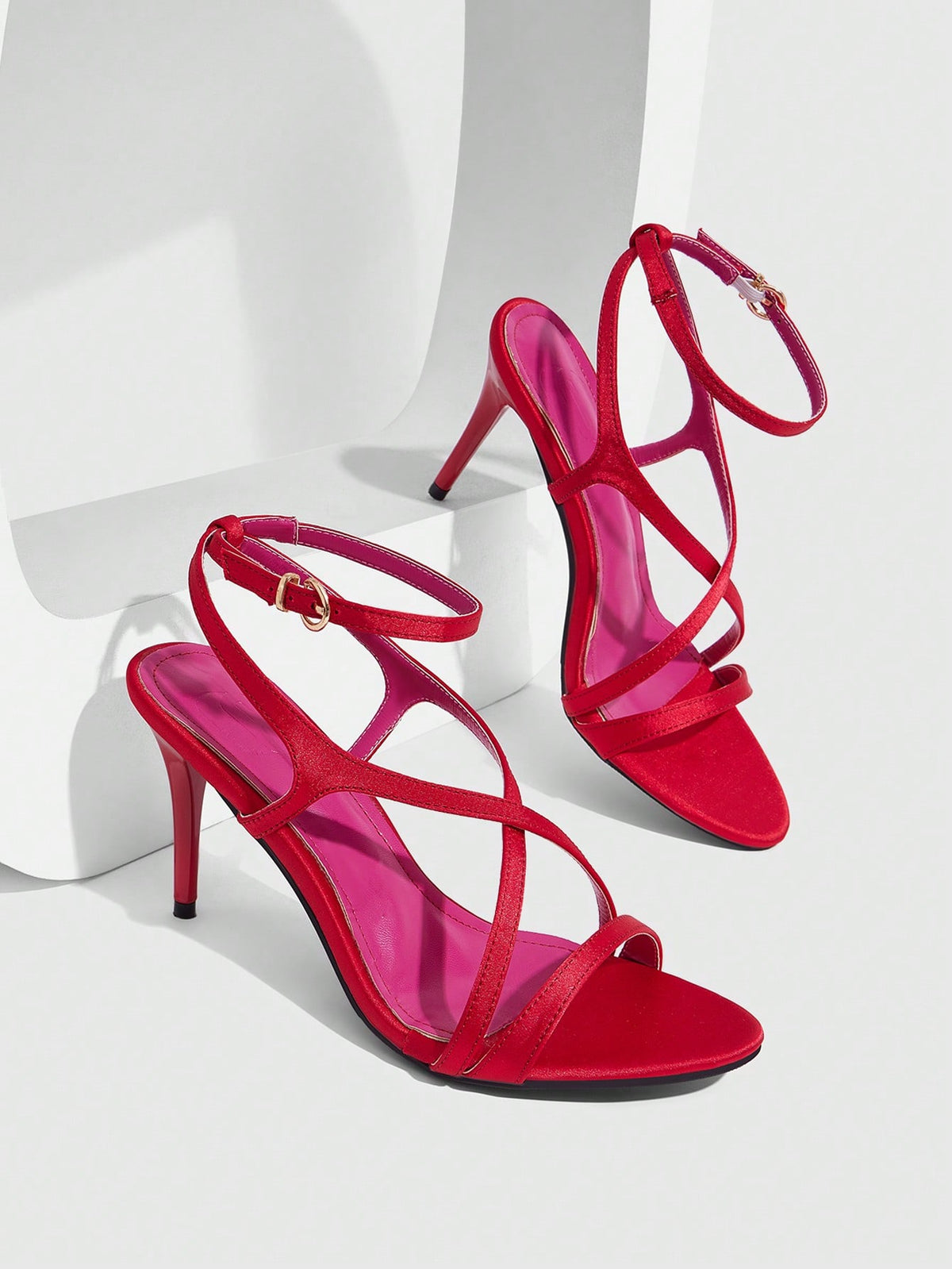 Square toe stiletto high heel sandals in deep burgundy satin featuring criss cross straps and an open toe design.