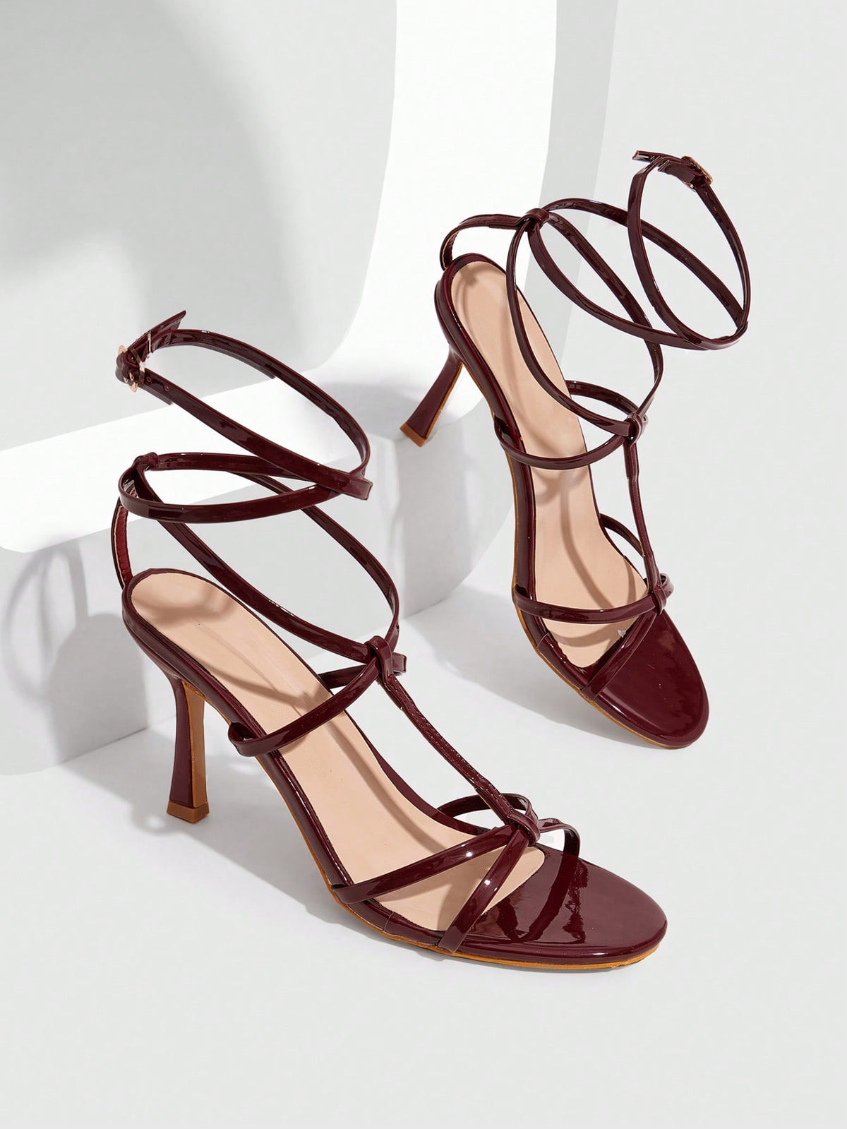 Women's open round toe high heel sandals with thin stiletto heel, hollow strap design, and ankle buckle closure.