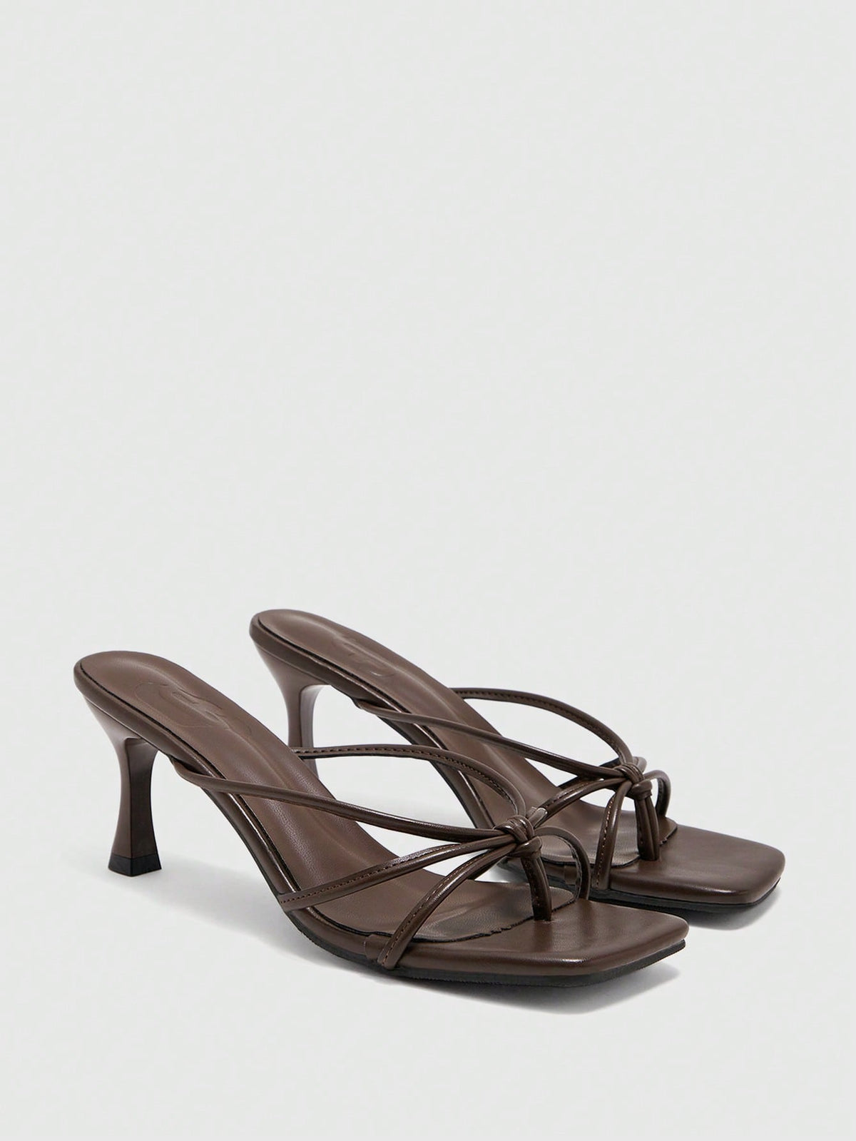 Square toe stiletto heel thong sandals for women featuring thin toe post strap, knot detail, and mid pyramid heel.