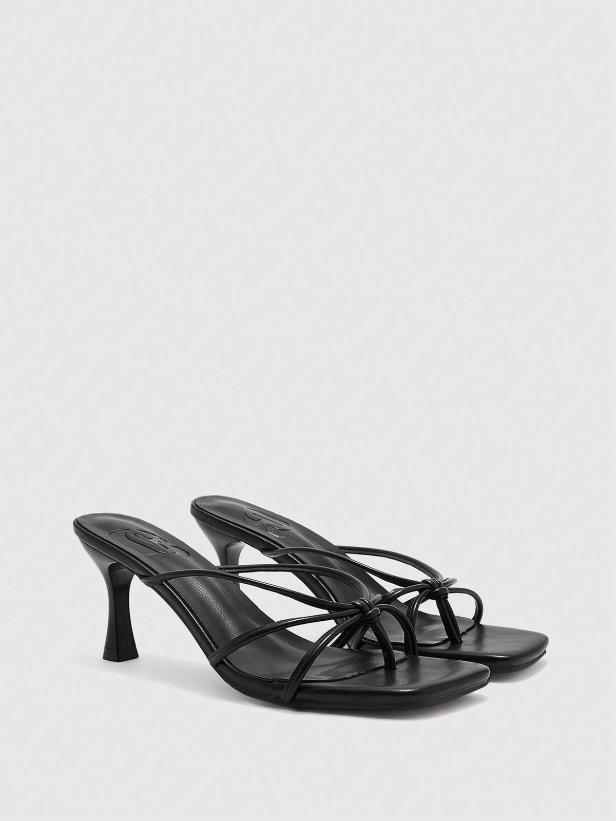 Square toe stiletto heel thong sandals for women featuring thin toe post strap, knot detail, and mid pyramid heel.
