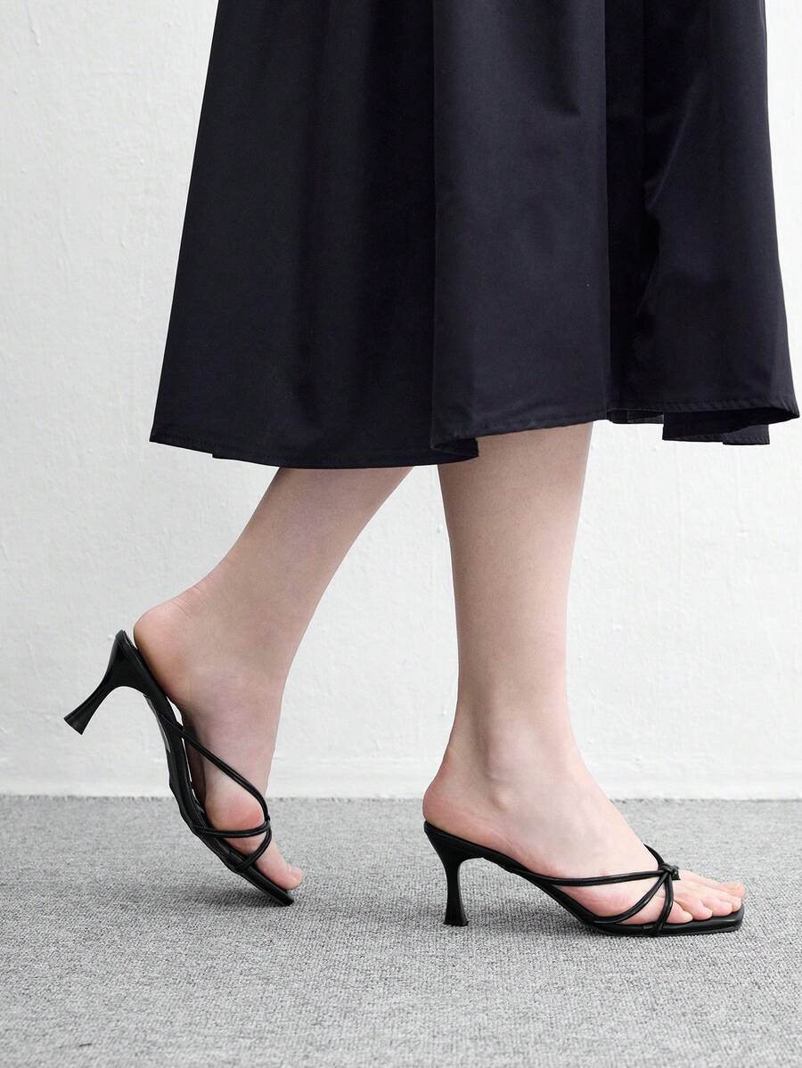 Square toe stiletto heel thong sandals for women featuring thin toe post strap, knot detail, and mid pyramid heel.