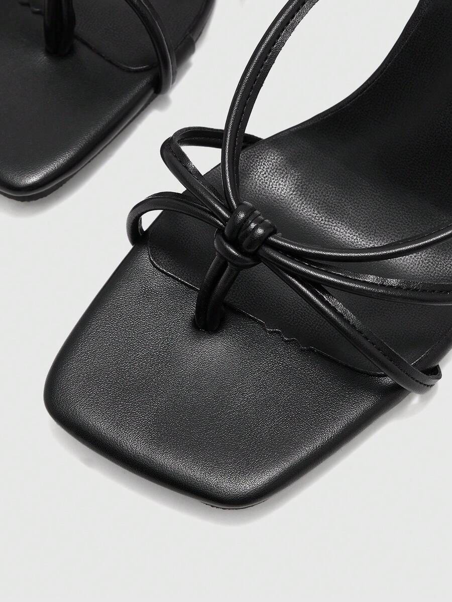 Square toe stiletto heel thong sandals for women featuring thin toe post strap, knot detail, and mid pyramid heel.
