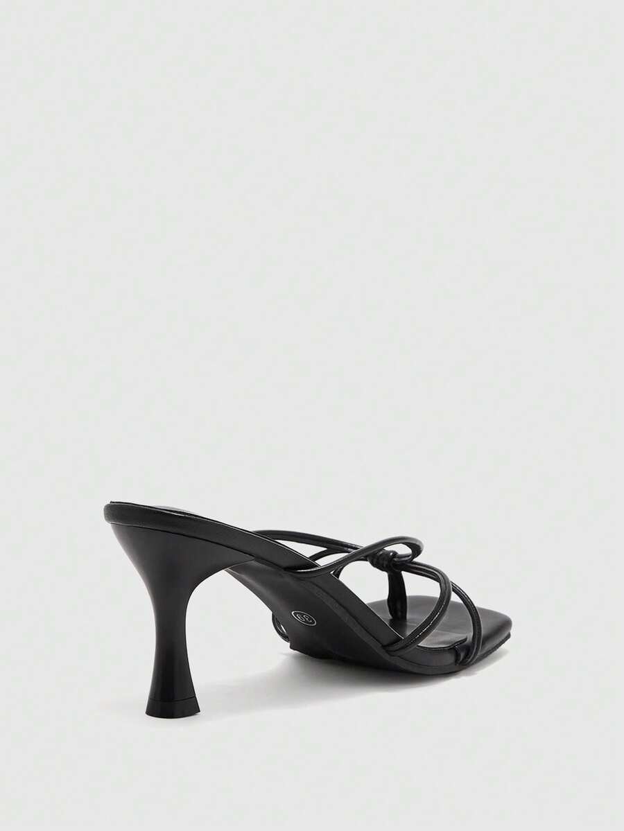 Square toe stiletto heel thong sandals for women featuring thin toe post strap, knot detail, and mid pyramid heel.