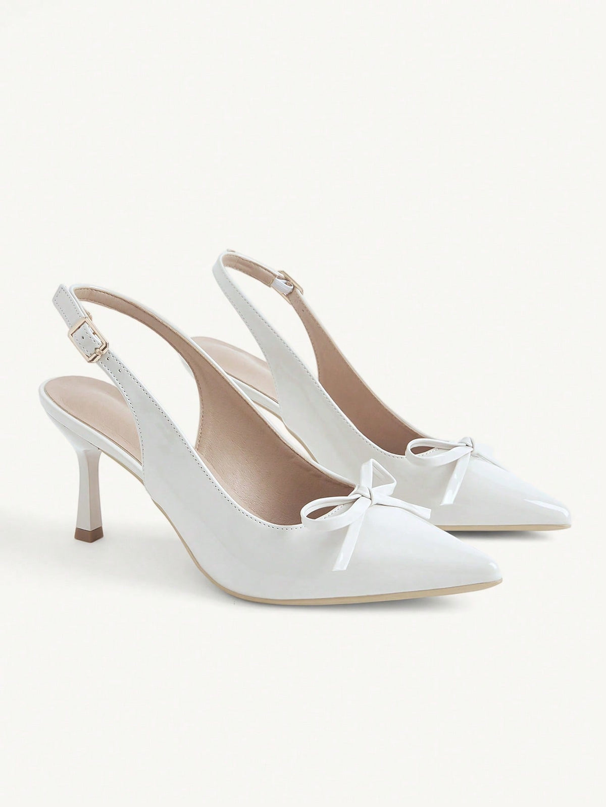 Beige pointed toe high heel pumps featuring a sleek stiletto heel and slingback strap for women.