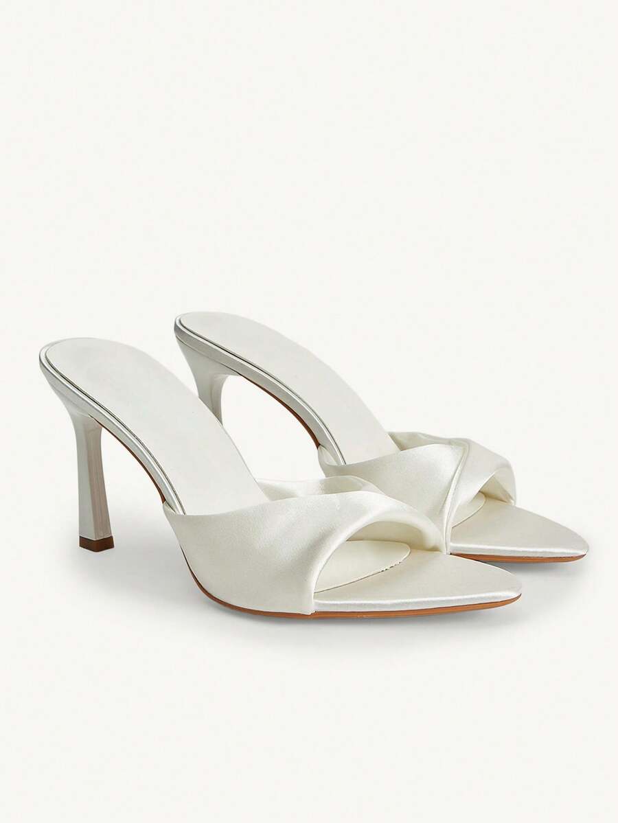 Women's peep toe high-heeled stiletto sandals with slingback strap in light metallic finish.