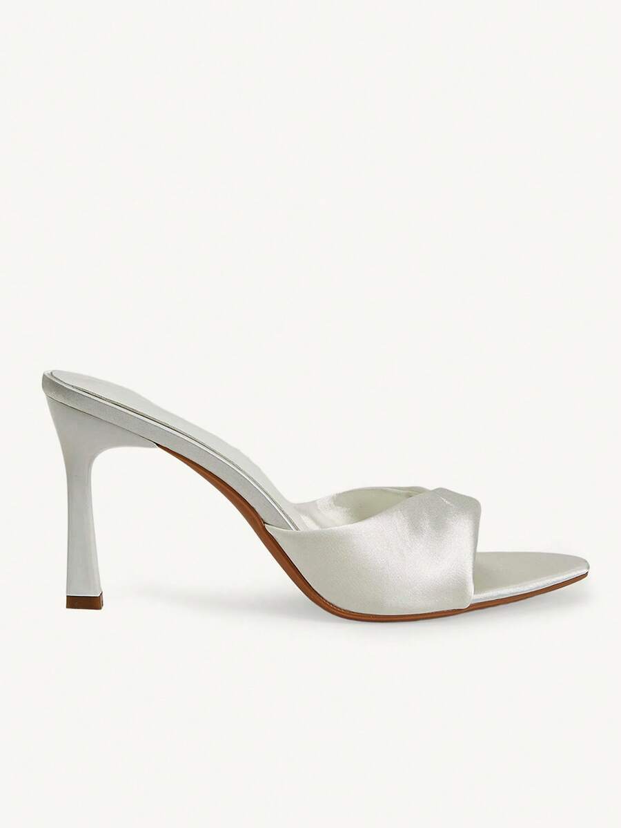 Women's peep toe high-heeled stiletto sandals with slingback strap in light metallic finish.