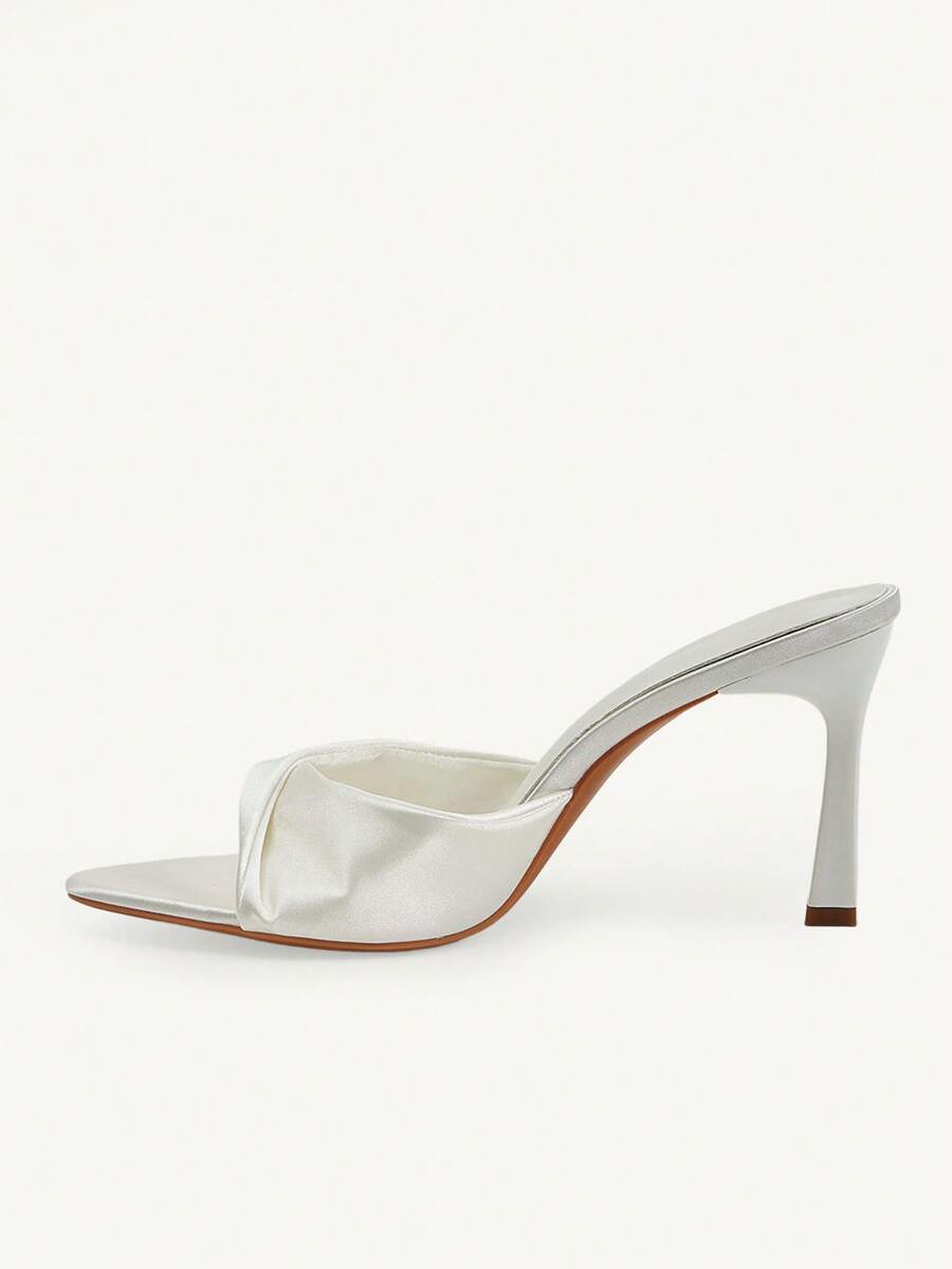 Women's peep toe high-heeled stiletto sandals with slingback strap in light metallic finish.
