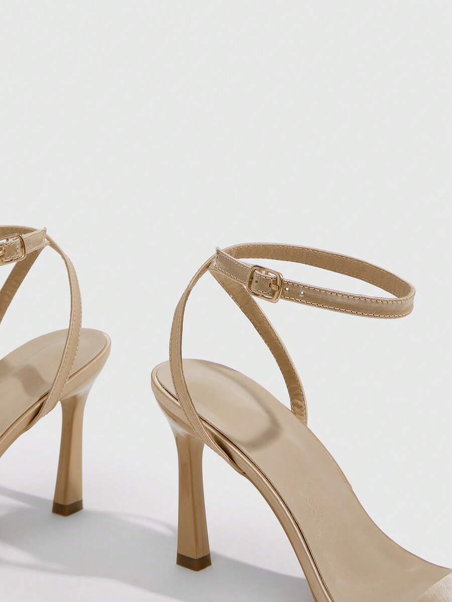 Women's high heel ankle strap sandals with open toe and stiletto heel in mirror black finish.