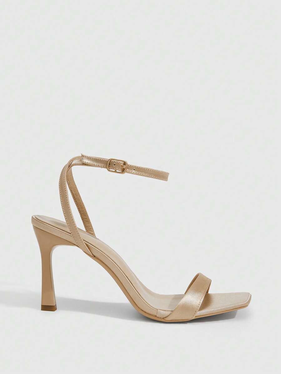 Women's high heel ankle strap sandals with open toe and stiletto heel in mirror black finish.