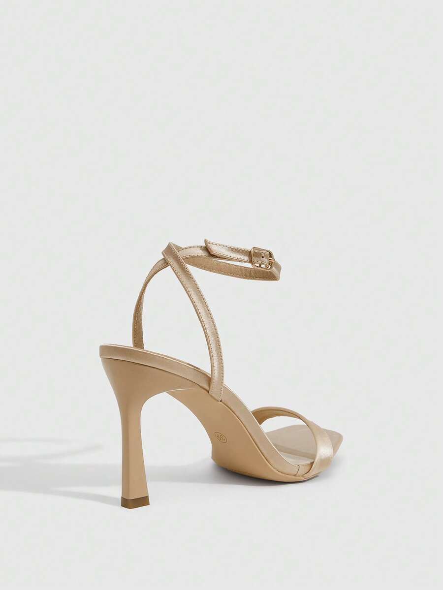 Women's high heel ankle strap sandals with open toe and stiletto heel in mirror black finish.