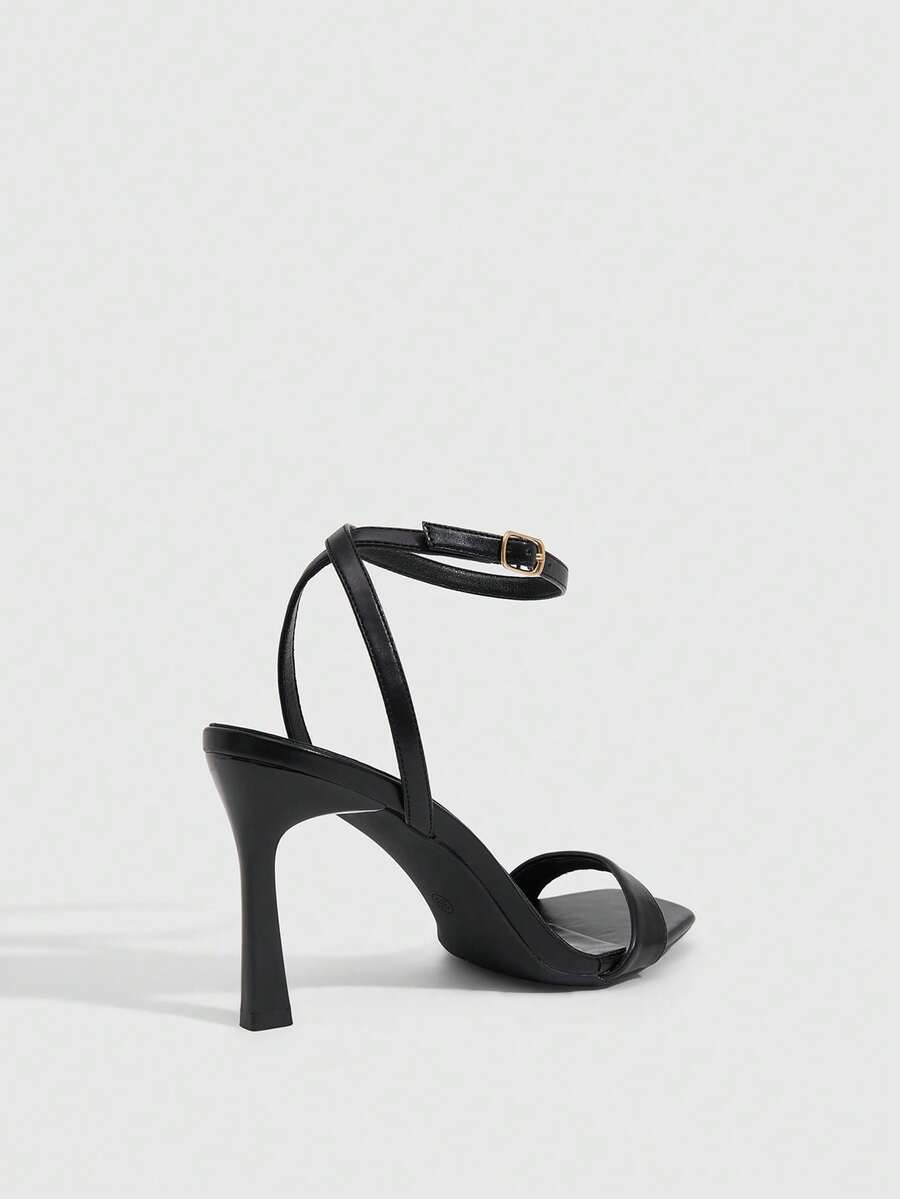 Women's high heel ankle strap sandals with open toe and stiletto heel in mirror black finish.