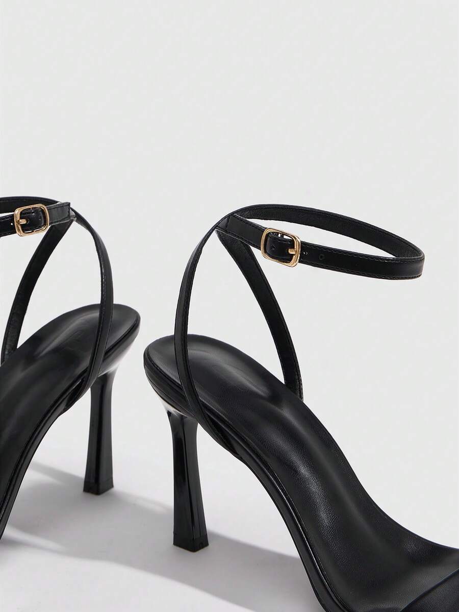 Women's high heel ankle strap sandals with open toe and stiletto heel in mirror black finish.