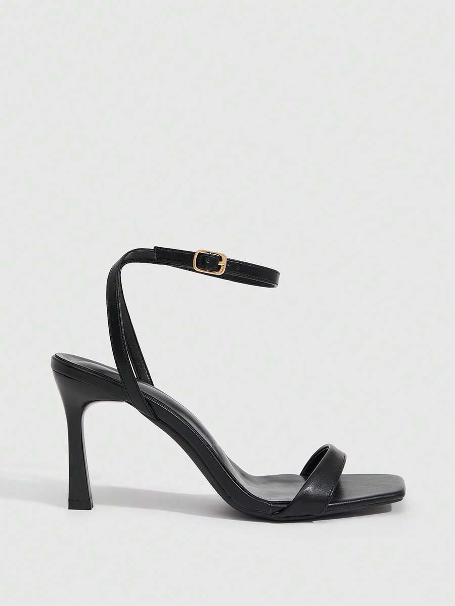 Women's high heel ankle strap sandals with open toe and stiletto heel in mirror black finish.