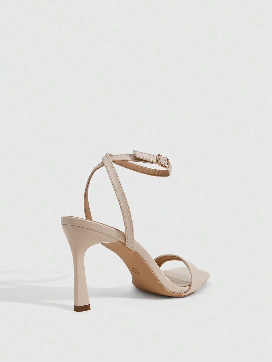 Women's high heel ankle strap sandals with open toe and stiletto heel in mirror black finish.