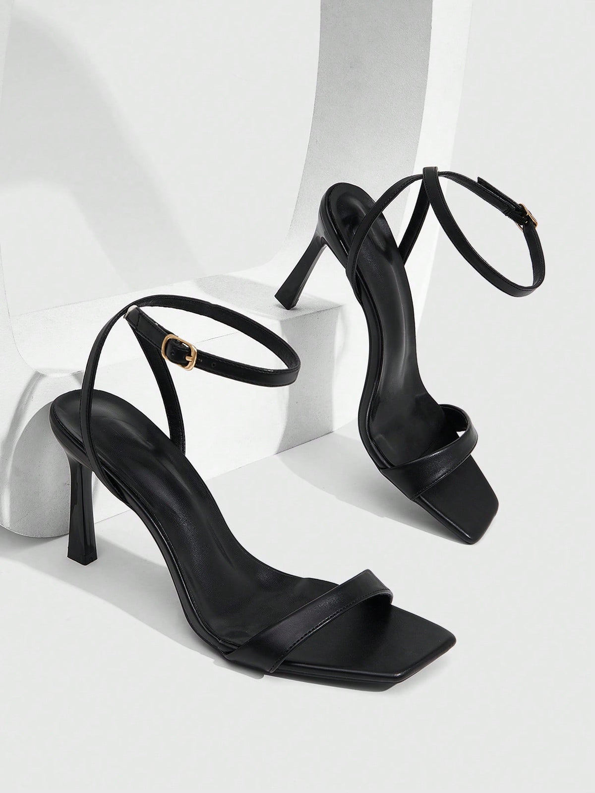 Women's high heel ankle strap sandals with open toe and stiletto heel in mirror black finish.