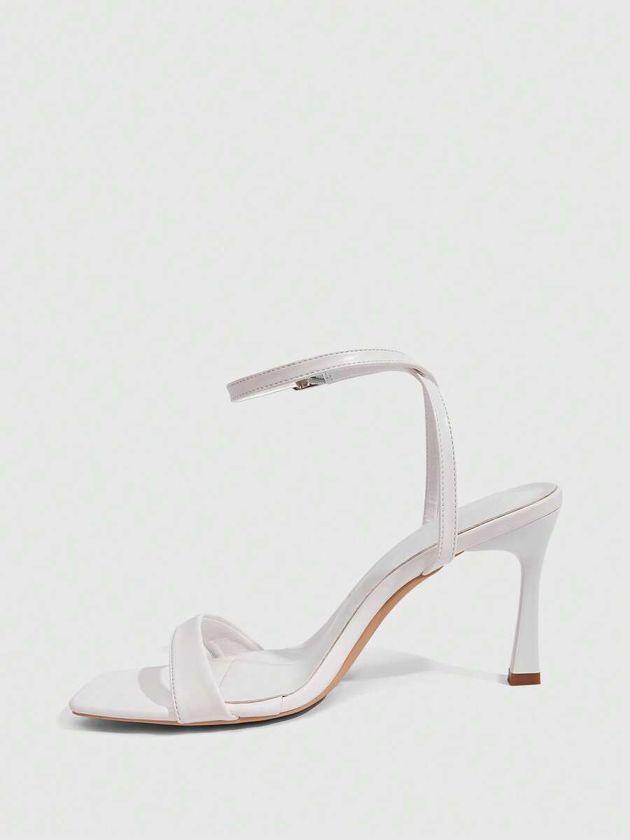 Women's high heel ankle strap sandals with open toe and stiletto heel in mirror black finish.