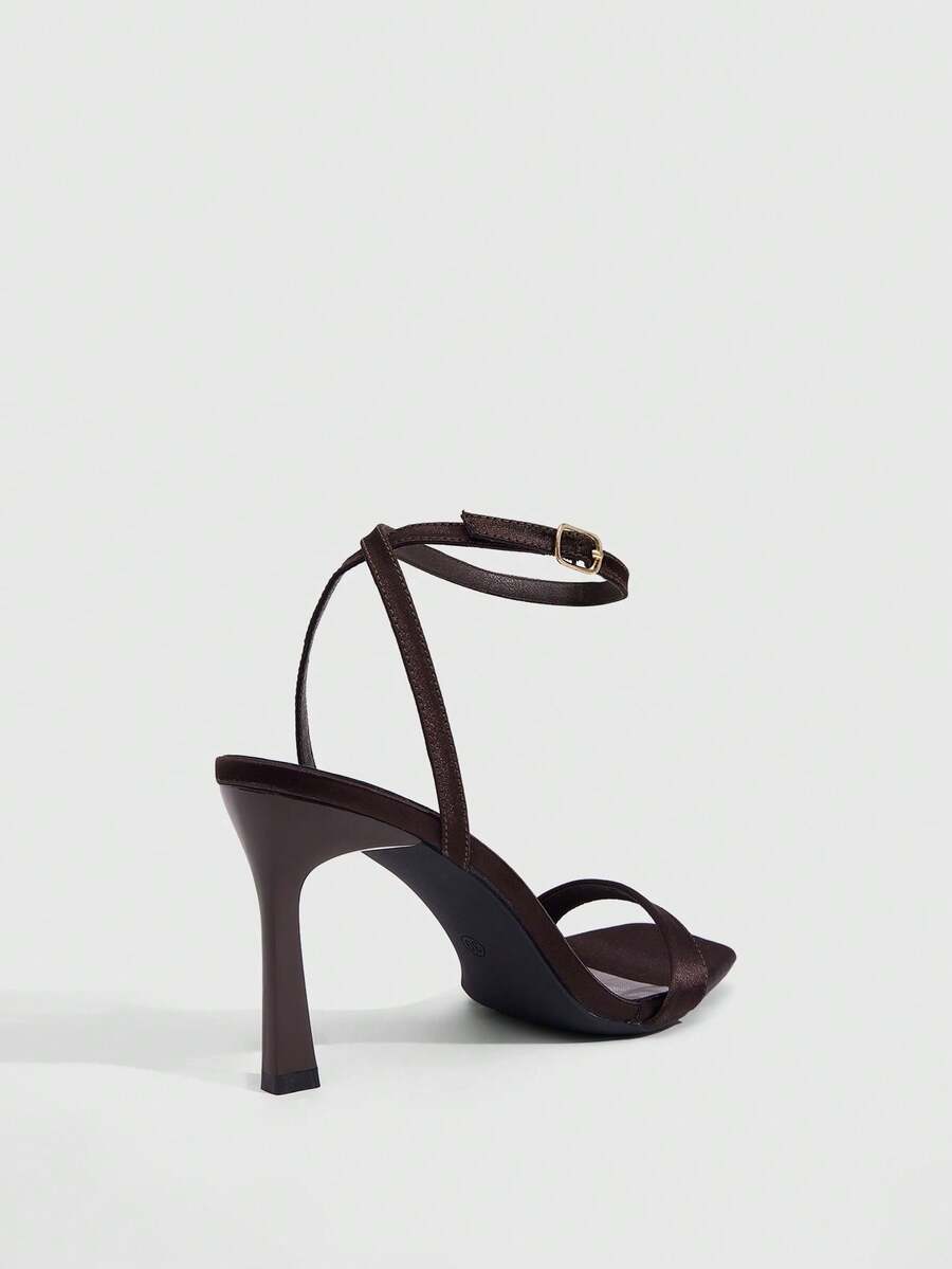 Women's high heel ankle strap sandals with open toe and stiletto heel in mirror black finish.