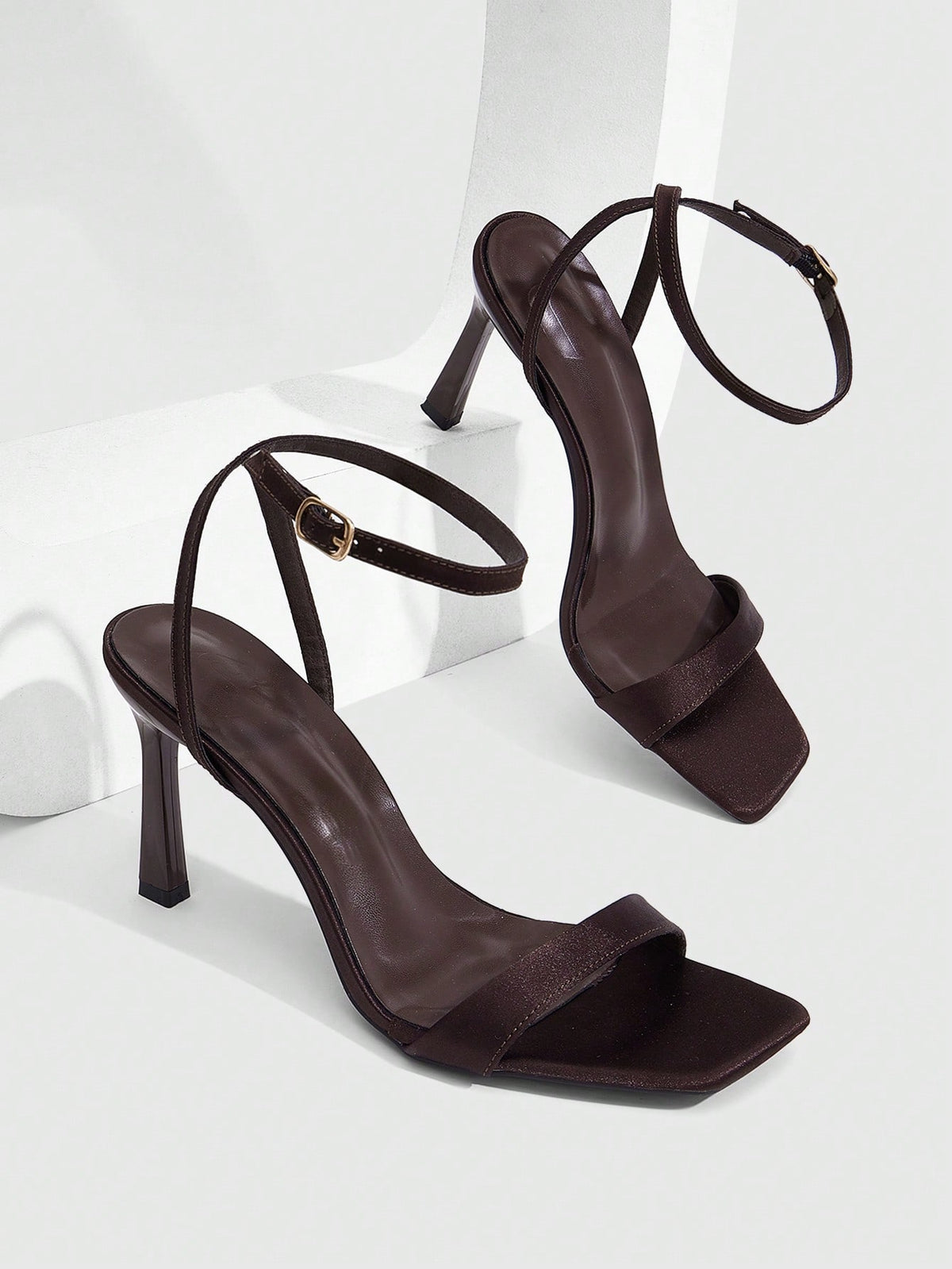 Women's high heel ankle strap sandals with open toe and stiletto heel in mirror black finish.