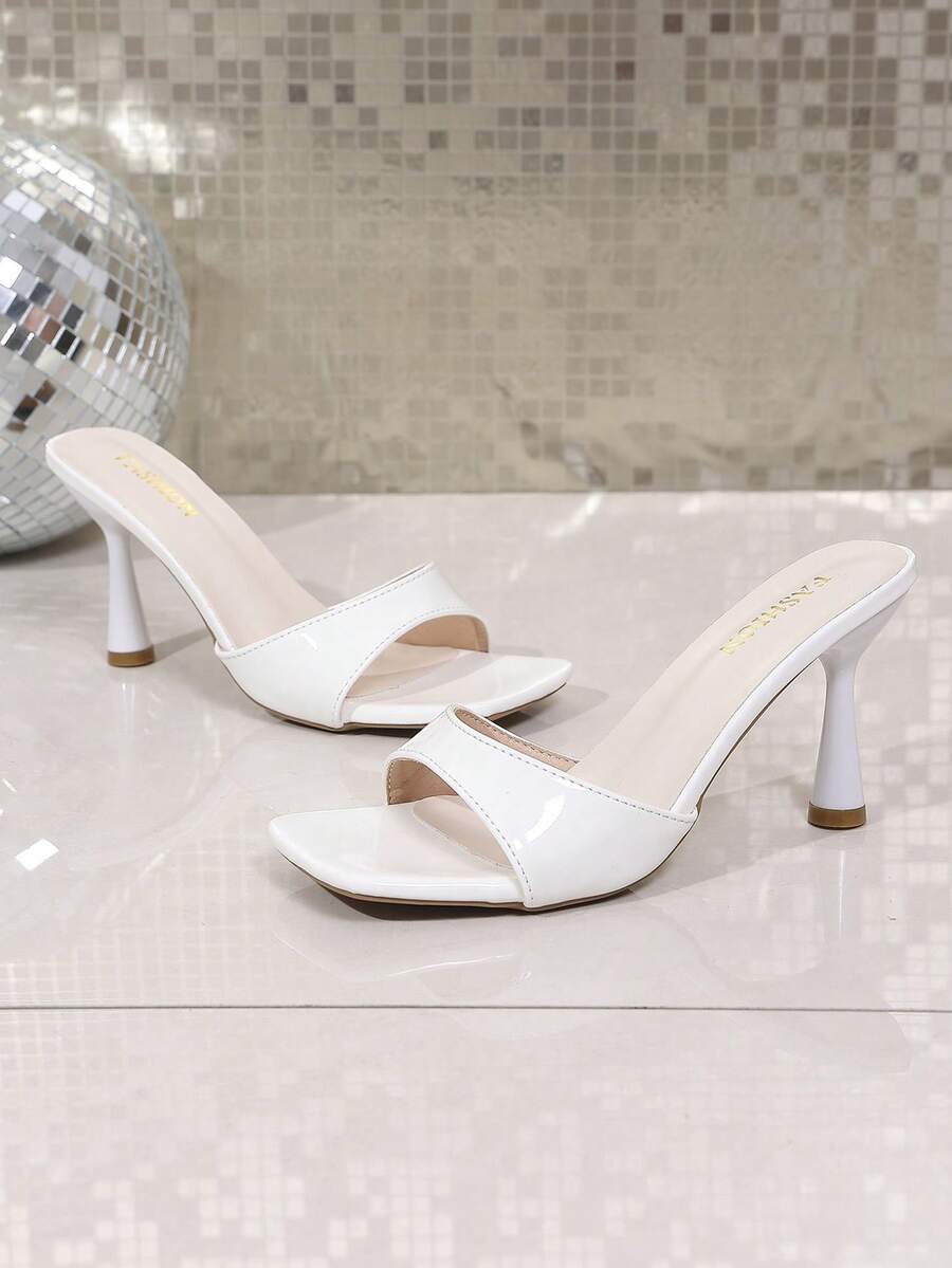 Pair of women's white square toe heeled mule sandals featuring open toe design and high stiletto heels