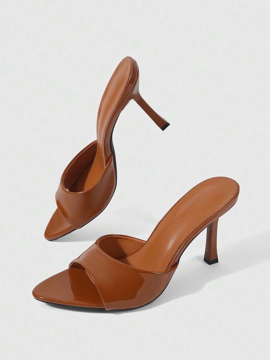 Women's high-heeled slippers in PU leather featuring an open plain toe, belt detail, and stiletto high heel with TPR outsole.