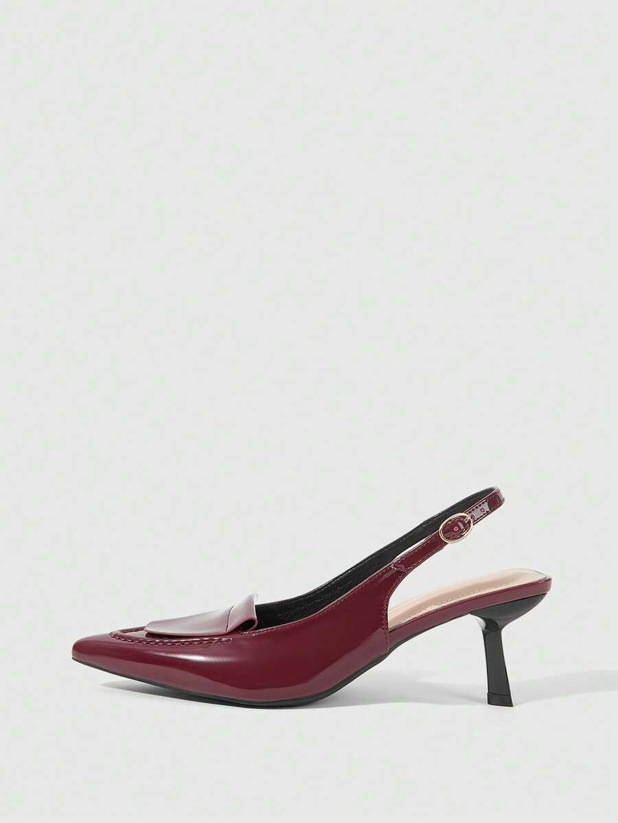 Women's pointed-toe high heel pumps in black mirror PU leather with an ankle strap, stiletto heel, and rhinestone buckle.