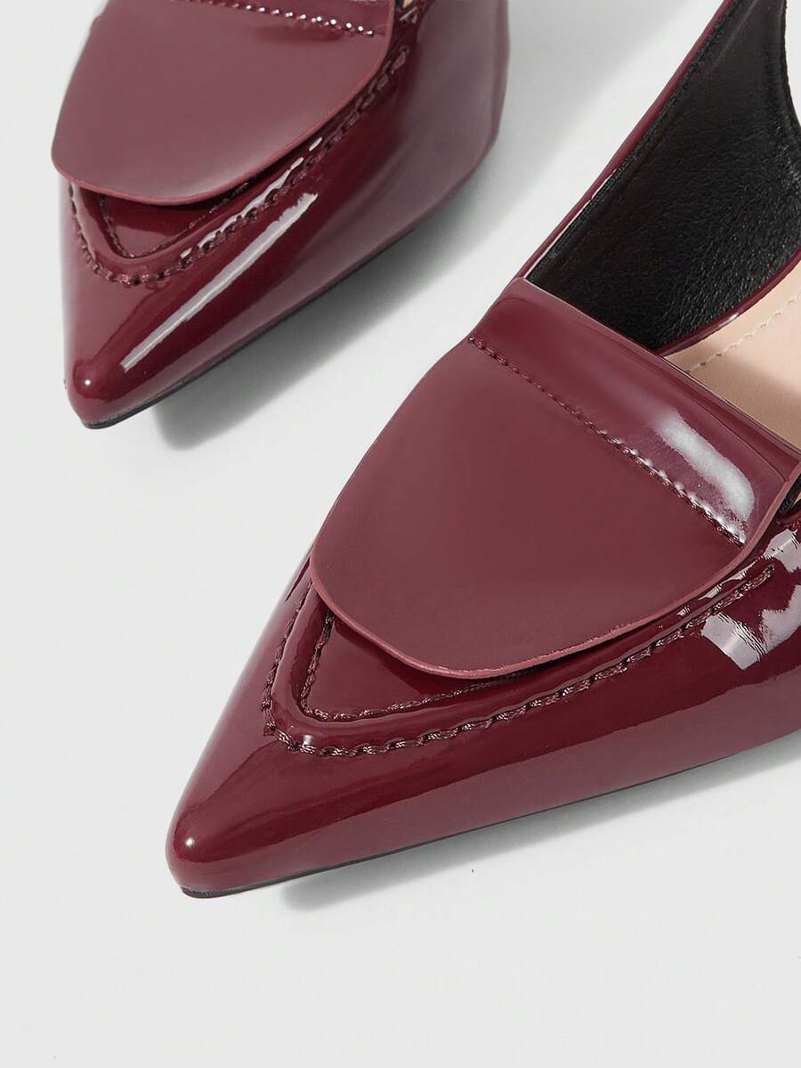 Women's pointed-toe high heel pumps in black mirror PU leather with an ankle strap, stiletto heel, and rhinestone buckle.
