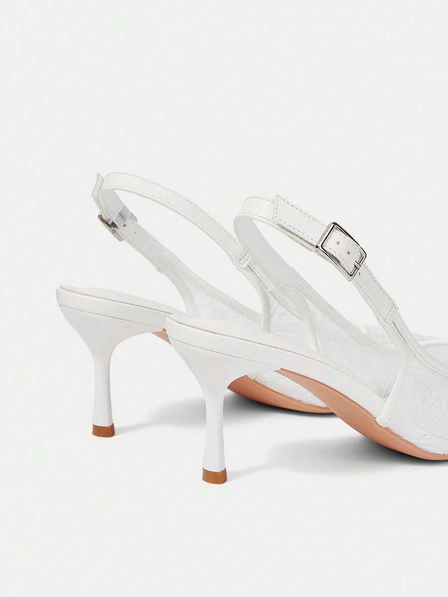 Pointed toe stiletto high heel pumps featuring black lace mesh upper, buckle slingback detail, and sleek slip-on design for weddings and evening wear.