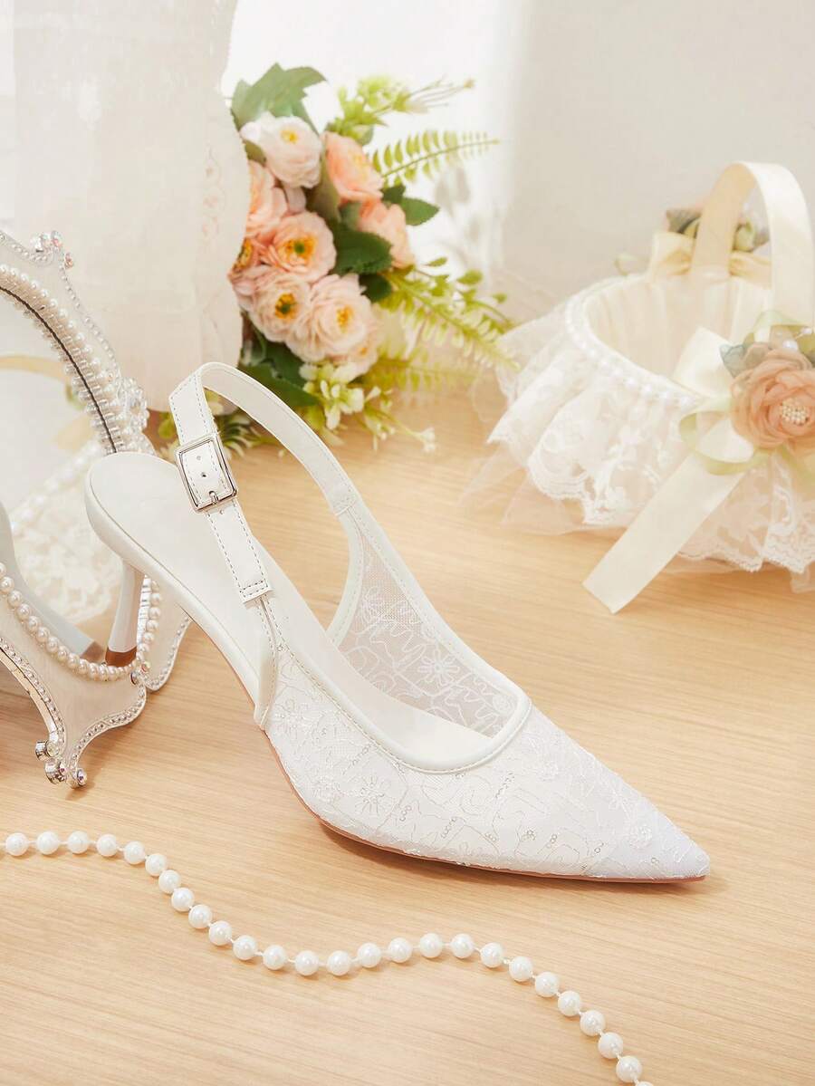Pointed toe stiletto high heel pumps featuring black lace mesh upper, buckle slingback detail, and sleek slip-on design for weddings and evening wear.
