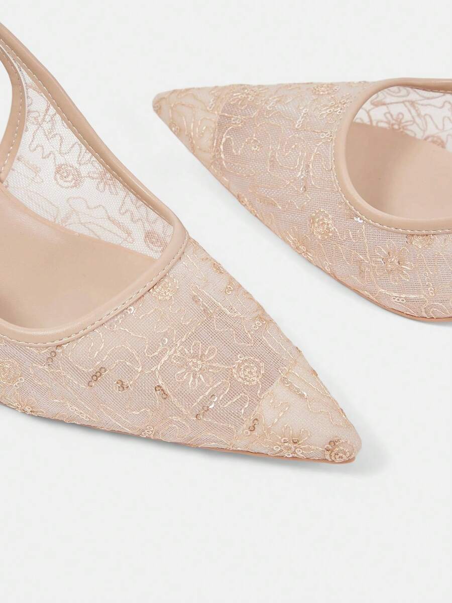Pointed toe stiletto high heel pumps featuring black lace mesh upper, buckle slingback detail, and sleek slip-on design for weddings and evening wear.