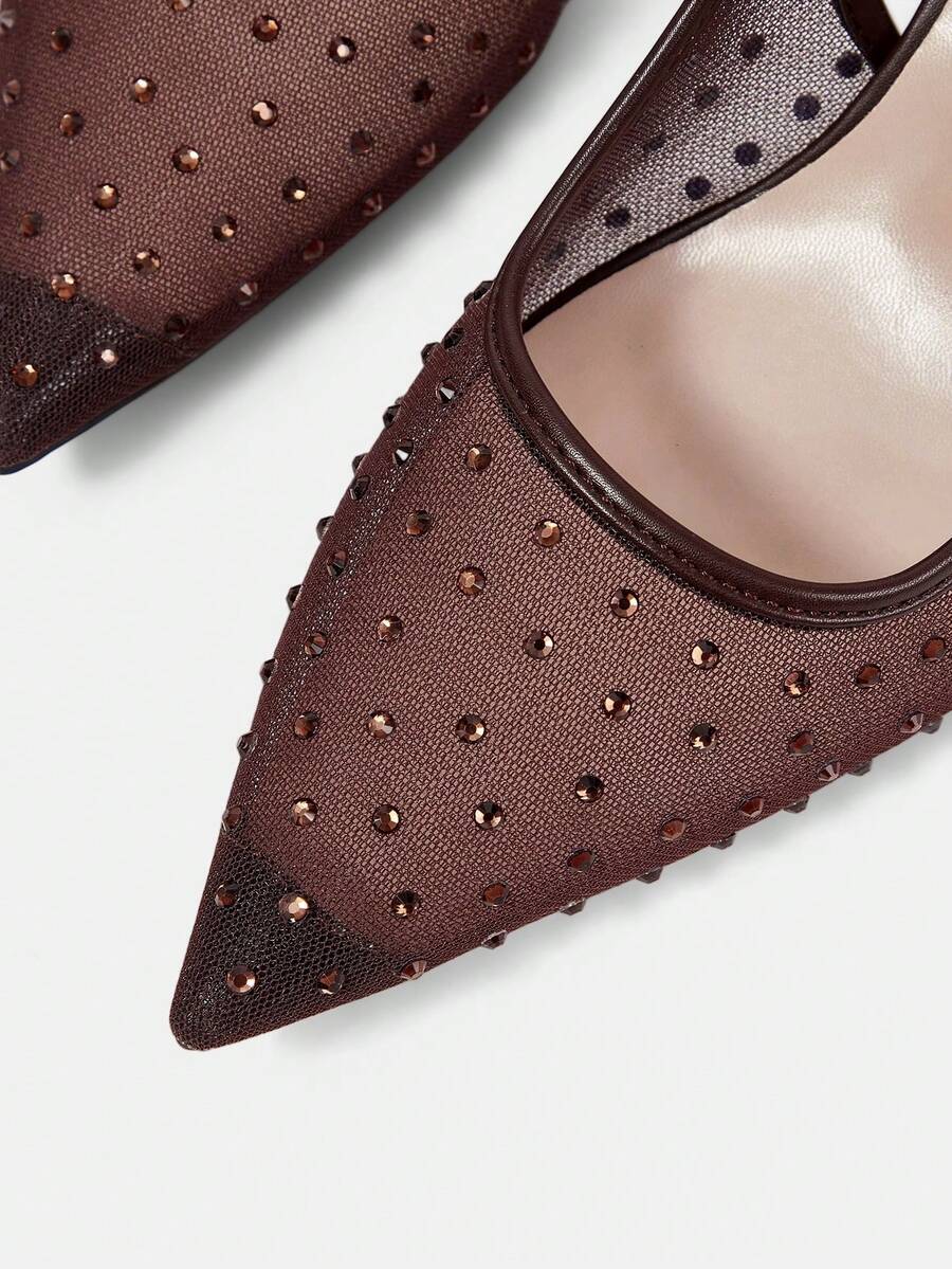 Pointed toe stiletto high heel pumps featuring black lace mesh upper, buckle slingback detail, and sleek slip-on design for weddings and evening wear.
