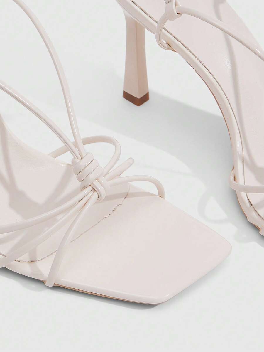 Women's square toe stiletto heel slingback sandals featuring sleek straps and buckle closure in a backless design.