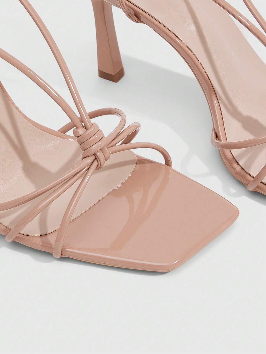 Women's square toe stiletto heel slingback sandals featuring sleek straps and buckle closure in a backless design.