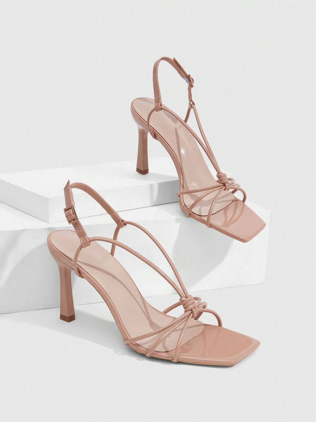 Women's square toe stiletto heel slingback sandals featuring sleek straps and buckle closure in a backless design.