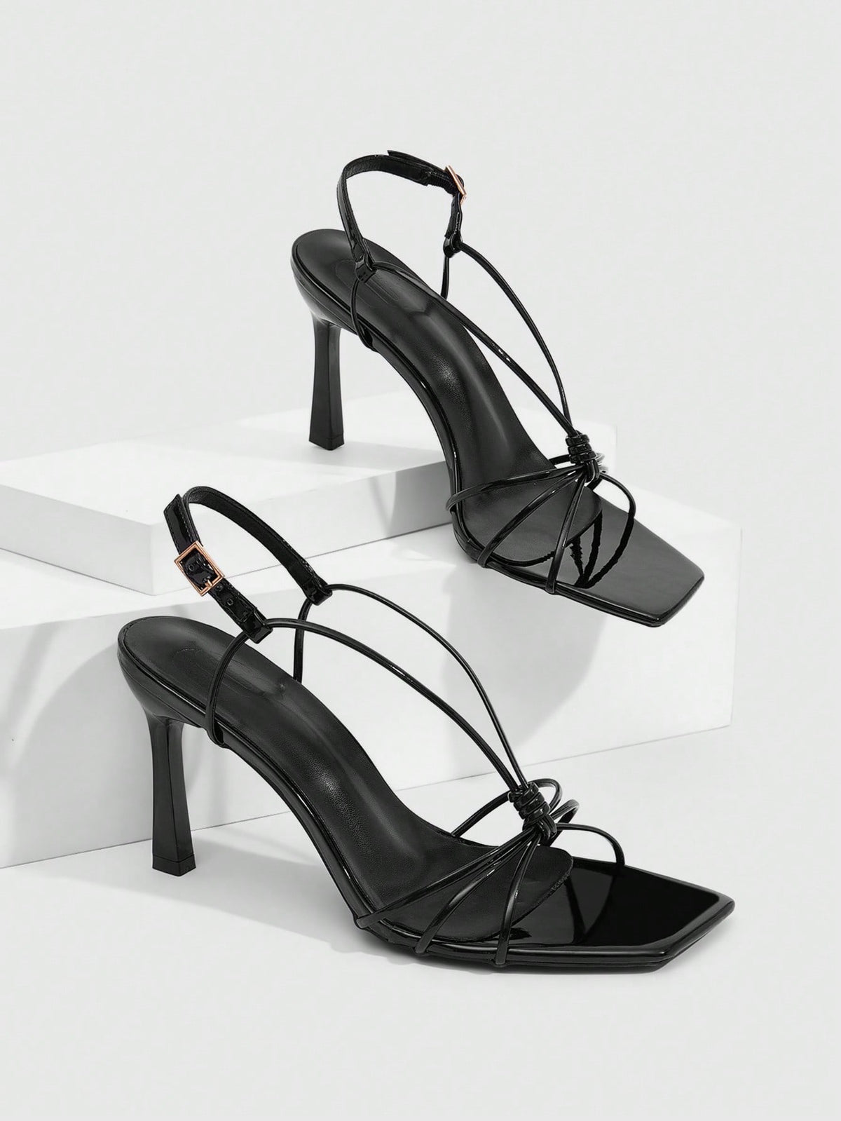 Women's square toe stiletto heel slingback sandals featuring sleek straps and buckle closure in a backless design.