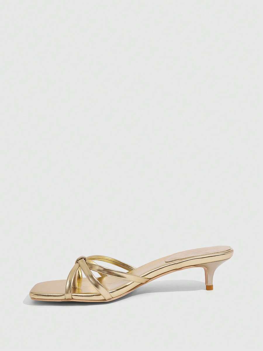 Square toe gold metallic heel sandals for women featuring open toe, crossover slingback strap, and stiletto mid heel for weddings and parties.