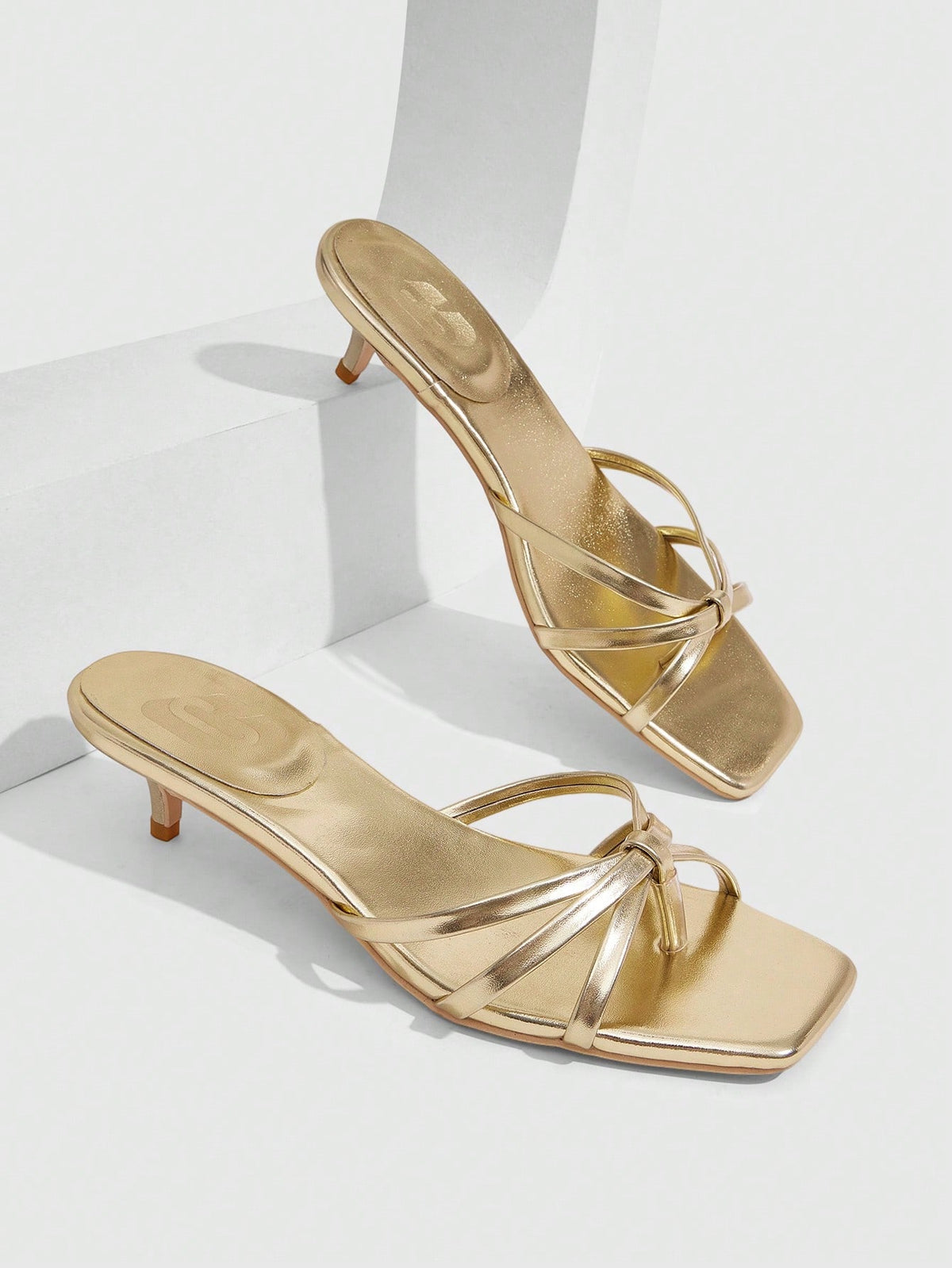 Square toe gold metallic heel sandals for women featuring open toe, crossover slingback strap, and stiletto mid heel for weddings and parties.