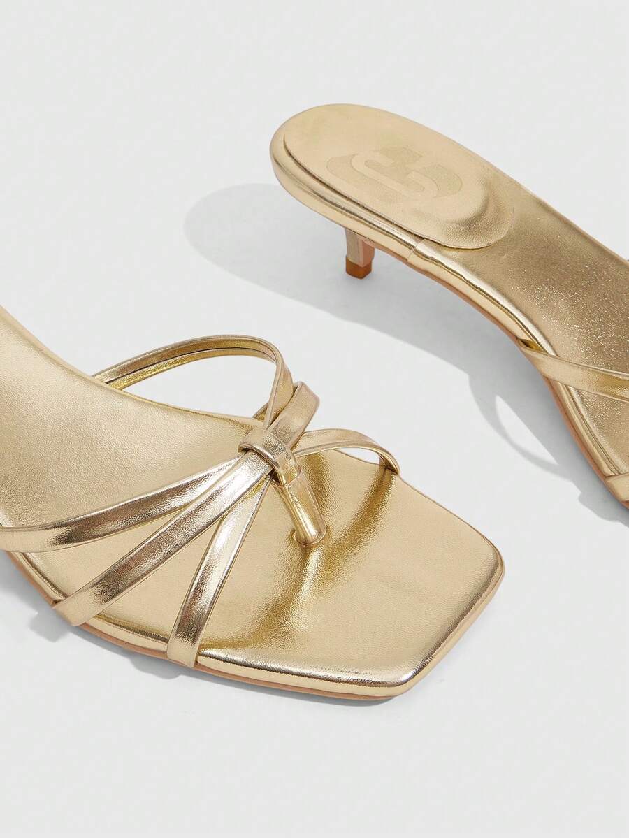 Square toe gold metallic heel sandals for women featuring open toe, crossover slingback strap, and stiletto mid heel for weddings and parties.